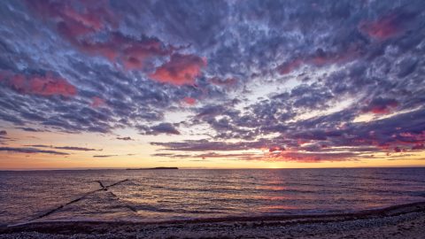 Bild: Sonnenuntergang an der Ostsee über der Insel Hiddensee in der Nähe von Dranske auf der Insel Rügen. OLYMPUS OM-D E-M5 mit LUMIX G VARIO 7-14mm / F4,0 ISO 200 ¦ f/9 ¦ 7 mm ¦ 1/30 s ¦ kein Blitz. Klicken Sie auf das Bild um es zu vergrößern.